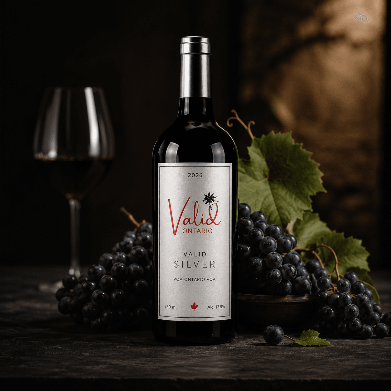 Valid Silver Ontario red wine bottle surrounded by dark grapes and a wine glass.